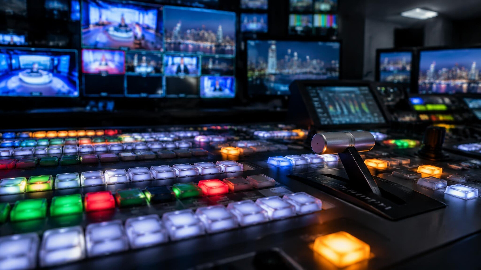 Video switcher desk with vision mixing controls in a control room